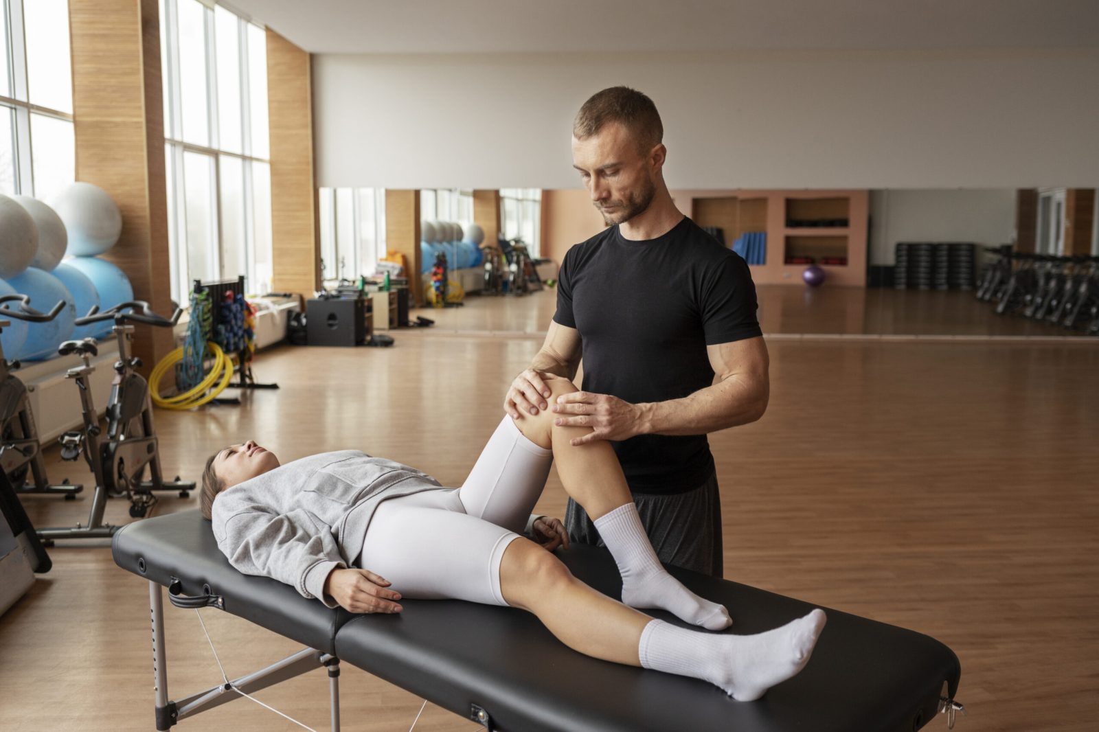 patient-doing-physical-rehabilitation-helped-by-therapists (1)